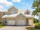 Charming townhouse featuring a two-car garage, well-maintained landscaping, and a bright, welcoming facade at 7021 Della Dr # 51, Orlando, FL 32819