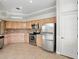 Kitchen featuring stainless steel appliances, tile floors and wooden cabinets at 7021 Della Dr # 51, Orlando, FL 32819