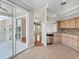 Open kitchen showcases stainless steel appliances, tile floors, and convenient access to outdoor patio at 7021 Della Dr # 51, Orlando, FL 32819