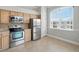 Kitchen features stainless steel appliances, oak cabinets, tile backsplash, and a window with a view at 7021 Della Dr # 51, Orlando, FL 32819