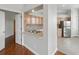 Partial view of kitchen with stainless steel appliances and pass-through to adjacent room at 7021 Della Dr # 51, Orlando, FL 32819