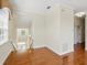 Bright landing area with hardwood floors, white trim, and view of front door at 7021 Della Dr # 51, Orlando, FL 32819