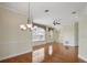 Open-concept living area with hardwood floors, recessed lighting, and a view to the staircase and dining room at 7021 Della Dr # 51, Orlando, FL 32819