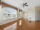 Bright living room features hardwood floors, ceiling fan, and large windows with sunlight streaming in at 7021 Della Dr # 51, Orlando, FL 32819