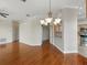 Open concept living space with hardwood floors leads to the kitchen with stainless steel appliances at 7021 Della Dr # 51, Orlando, FL 32819