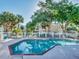 Community pool with white fencing and lounge chairs surrounded by lush landscaping at 7021 Della Dr # 51, Orlando, FL 32819
