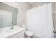 Clean and simple bathroom with a toilet, vanity, shower and white tile is very functional at 711 Swan Ln, Altamonte Springs, FL 32701