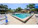 Community swimming pool surrounded by lounge chairs and palm trees, for outdoor enjoyment at 711 Swan Ln, Altamonte Springs, FL 32701
