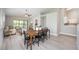 Bright dining area with modern gray flooring leading into a living area and kitchen at 711 Swan Ln, Altamonte Springs, FL 32701