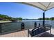 Dockside bench offers serene lake view under a canopy, perfect for relaxation and enjoying the waterfront scenery at 711 Swan Ln, Altamonte Springs, FL 32701