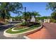 Well-maintained community entrance with lush landscaping, signage, and secure gates at 711 Swan Ln, Altamonte Springs, FL 32701