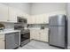 Functional kitchen features sleek stainless steel appliances and ample cabinet space at 711 Swan Ln, Altamonte Springs, FL 32701