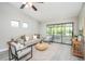 Open living room with neutral tones, ceiling fan, and sliding glass doors to a screened-in porch at 711 Swan Ln, Altamonte Springs, FL 32701