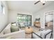 Comfortable living room features an inviting color scheme, fan, and access to a screened-in porch at 711 Swan Ln, Altamonte Springs, FL 32701