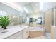 Bright main bathroom offers a soaking tub, walk-in shower, and skylight for a spa-like experience at 711 Swan Ln, Altamonte Springs, FL 32701