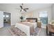 Spacious main bedroom offers a ceiling fan, natural light, and calming decor for a serene retreat at 711 Swan Ln, Altamonte Springs, FL 32701