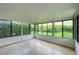 Bright sunroom surrounded by windows offering an outdoor view of landscaping at 711 Swan Ln, Altamonte Springs, FL 32701