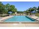 A pristine community pool with lounge chairs and umbrellas, perfect for relaxation at 711 Swan Ln, Altamonte Springs, FL 32701