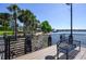 Scenic waterfront view with palm trees, a bench, and a glimpse of sailboats on the water at 711 Swan Ln, Altamonte Springs, FL 32701