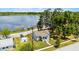 An aerial view of the charming house with a well-maintained lawn and views of the lake at 730 S Main Ave, Groveland, FL 34736