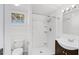 Bathroom features standing shower, white walls, and dark vanity at 730 S Main Ave, Groveland, FL 34736