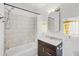 Updated bathroom with marble-look shower, modern vanity, and decorative mirror at 730 S Main Ave, Groveland, FL 34736