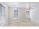 Bright bedroom featuring neutral walls, carpet floors, built in storage, and two windows at 730 S Main Ave, Groveland, FL 34736