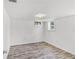 Bright bedroom features neutral walls and wood-look flooring at 730 S Main Ave, Groveland, FL 34736