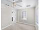 Bright bedroom featuring neutral walls, carpet floors, and a window at 730 S Main Ave, Groveland, FL 34736