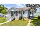Charming home featuring a welcoming front porch, well-maintained lawn, and classic architectural details at 730 S Main Ave, Groveland, FL 34736
