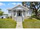 Charming home featuring a welcoming front porch, stone accents and manicured lawn at 730 S Main Ave, Groveland, FL 34736