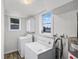 Laundry room with appliances, cabinets, and windows for natural light at 730 S Main Ave, Groveland, FL 34736