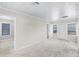 Bright living room featuring neutral walls, carpet floors, and plenty of natural light at 730 S Main Ave, Groveland, FL 34736