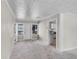 Bright living room with neutral walls, carpeted floors, and an open doorway to the kitchen at 730 S Main Ave, Groveland, FL 34736