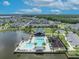 Scenic aerial of community amenities including pool, clubhouse, and playground by a lake, amidst residential homes at 744 Yukon Ln, Debary, FL 32713