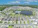 Aerial view featuring a community amenity center, lake, and a neighborhood featuring modern homes with garages at 744 Yukon Ln, Debary, FL 32713