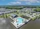 Overhead shot showcasing a community pool, clubhouse, and playground set on a lakefront within a neighborhood at 744 Yukon Ln, Debary, FL 32713