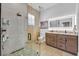 Modern bathroom showcasing a glass walk-in shower, dual sink vanity, and stylish lighting fixtures at 744 Yukon Ln, Debary, FL 32713