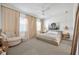 Serene bedroom with neutral tones, a lion artwork, a ceiling fan, and cozy furnishings at 744 Yukon Ln, Debary, FL 32713