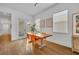 Bright dining area with hardwood floors, a wooden table, and stylish orange chairs at 744 Yukon Ln, Debary, FL 32713