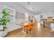 Modern dining area with a wood table and seating, natural light, and views of the living area and kitchen at 744 Yukon Ln, Debary, FL 32713