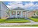 Attractive single-story home with a lush green lawn, inviting covered porch, and eye-catching stone accents at 744 Yukon Ln, Debary, FL 32713