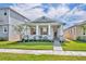 Inviting single-story home featuring a well-maintained lawn, a covered front porch, and stone detailing at 744 Yukon Ln, Debary, FL 32713