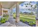 Relaxing front porch featuring stone pillars, brick flooring and view to community amenities at 744 Yukon Ln, Debary, FL 32713