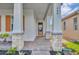 Welcoming front porch with stone columns, brick pavers, and a modern front door, creating a stylish entrance at 744 Yukon Ln, Debary, FL 32713