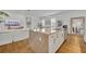 Kitchen island opens to the living area, stainless steel appliances, with white cabinets and light countertops at 744 Yukon Ln, Debary, FL 32713