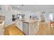 Open kitchen with island, stainless appliances, white cabinets, and seamless flow to the living spaces at 744 Yukon Ln, Debary, FL 32713