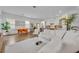 Bright, open-concept living and dining area with stylish decor and hardwood flooring throughout at 744 Yukon Ln, Debary, FL 32713