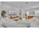 Open-concept living area with hardwood floors, white sofas, and stylish decor adjacent to the dining area at 744 Yukon Ln, Debary, FL 32713