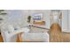 Bright living room features hardwood floors, a large white sofa, and stylish modern decor at 744 Yukon Ln, Debary, FL 32713